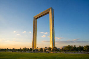 Dubai Frame glowing at golden hour above the green lawns of Zabeel Park