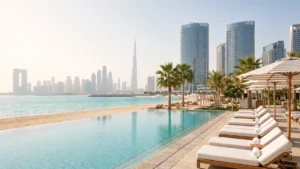 Dubai hotel swimming pool beside a beach with skyline views