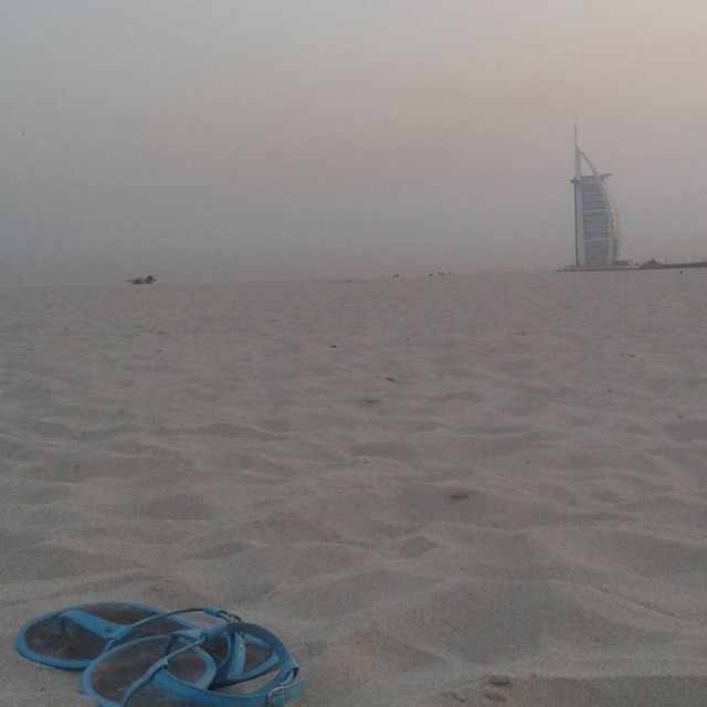 Flip-flops on the sand at Secret Beach at sunrise